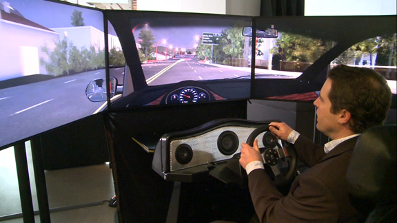 Jason Medal-Katz, the Autodesk Gallery's onsite curator, demonstrates the drive simulator.