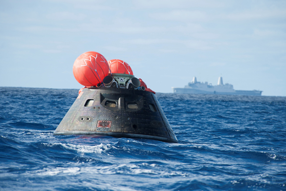 The Orion in the water, awaiting recovery (image courtesy of NASA).