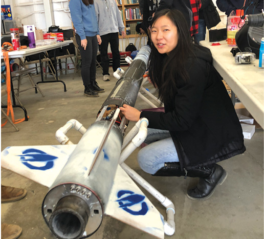 A UCLA student with a liquid fuel rocket. Image courtesy of Base 11.